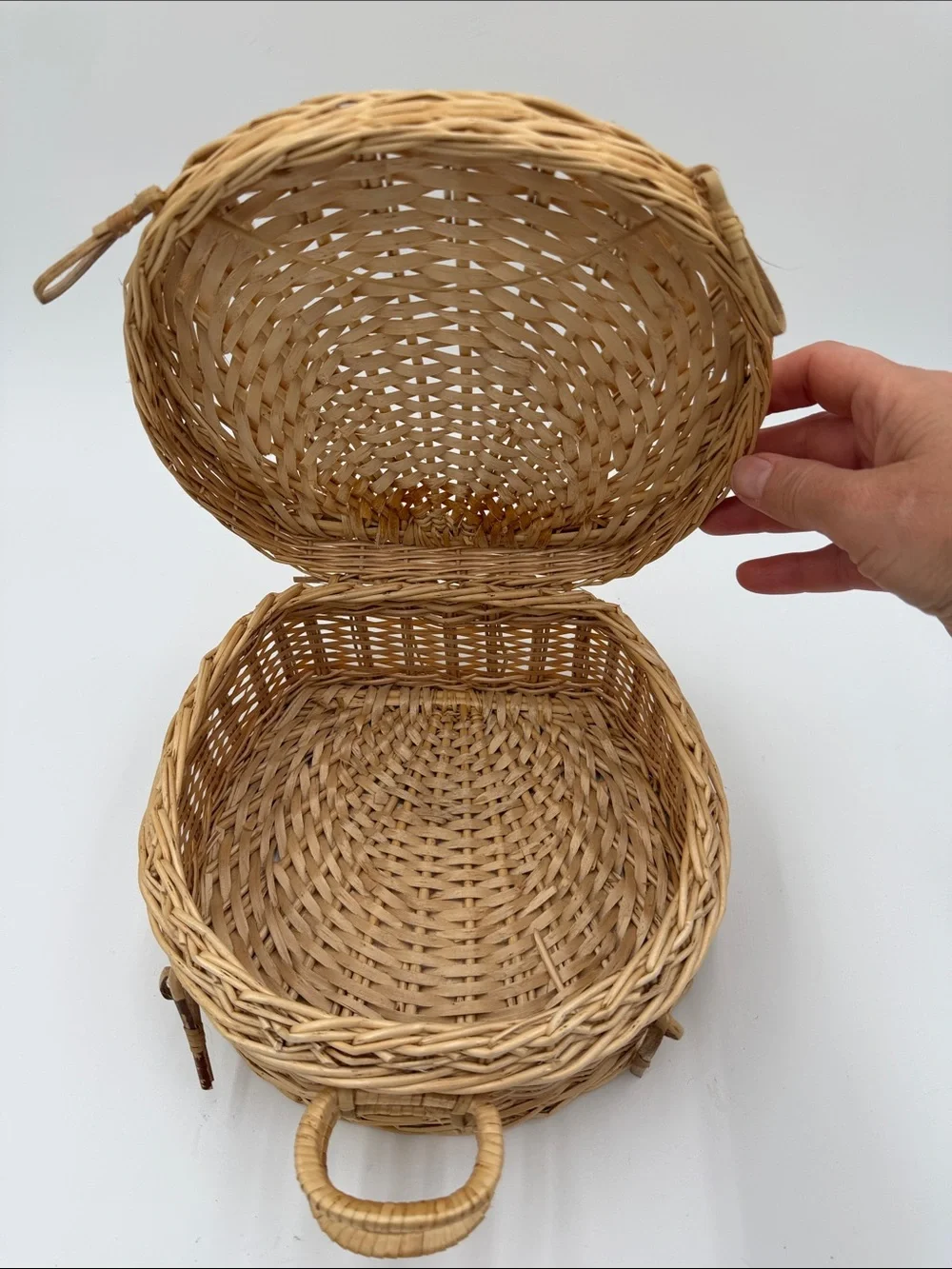 A Cute, charming vintage shell-shaped rattan storage basket with a front handle.